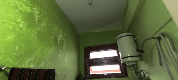 A window with a chipped paint on the wall AI-generated content may be incorrect.